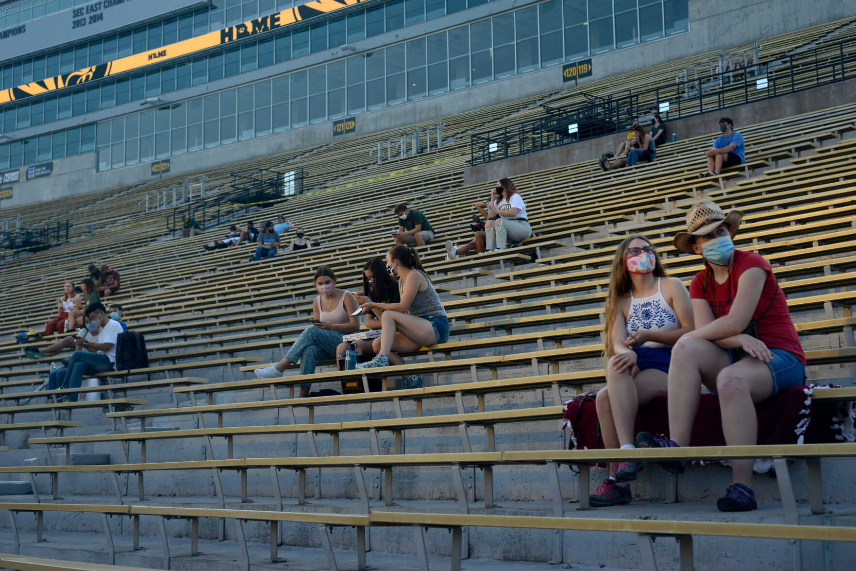 Several groups of friends sit, socially distanced, while they wait for "Star Wars: The Rise of Skywalker" to start
